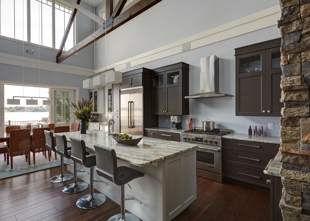 Kitchen - transitional l-shaped dark wood floor and brown floor kitchen idea in Chicago with shaker cabinets, brown cabinets, stainless steel appliances and an island