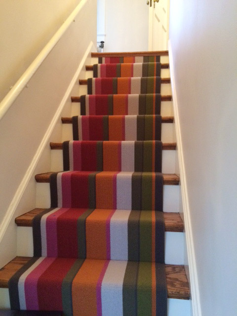 Transitional carpeted straight staircase in Philadelphia with carpet risers.