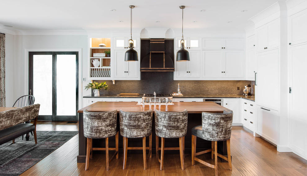 Design ideas for a large transitional l-shaped eat-in kitchen in Toronto with white cabinets, grey splashback, with island, a farmhouse sink, shaker cabinets, wood benchtops, mosaic tile splashback, panelled appliances, medium hardwood floors and brown floor.