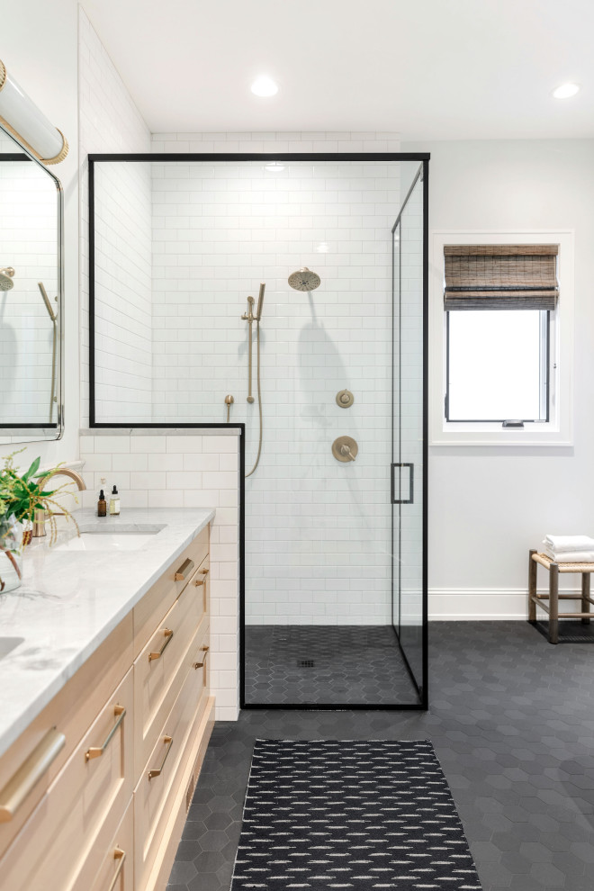 Example of a mid-sized master white tile and subway tile concrete floor and double-sink bathroom design in Calgary with recessed-panel cabinets, light wood cabinets, a one-piece toilet, white walls, an undermount sink, marble countertops, a hinged shower door, white countertops and a floating vanity