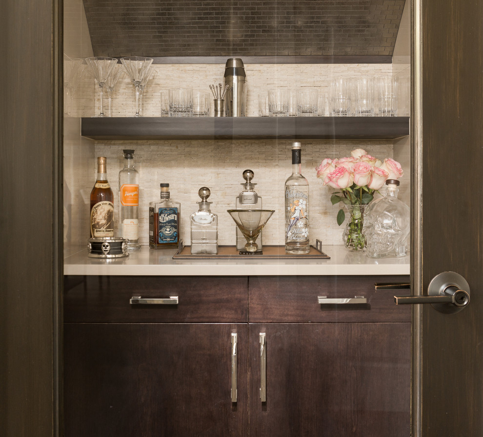 Inspiration for a small contemporary single-wall wet bar in Detroit with dark wood cabinets, quartz benchtops, beige splashback, stone tile splashback and flat-panel cabinets.