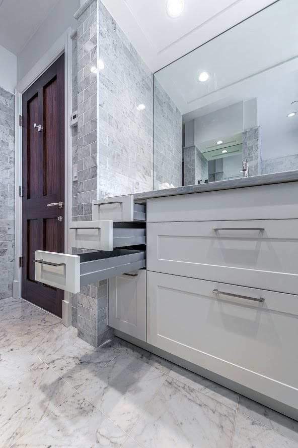 Expansive modern bathroom in New York with shaker cabinets and white cabinets.