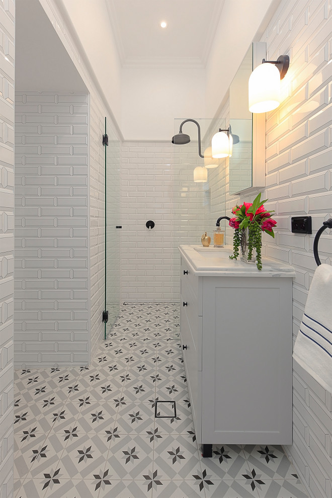 Design ideas for a medium sized classic bathroom in Sydney with shaker cabinets, grey cabinets, a freestanding bath, a corner shower, a one-piece toilet, white tiles, ceramic tiles, white walls, ceramic flooring, a built-in sink, engineered stone worktops, grey floors, a hinged door, grey worktops, a laundry area and a single sink.
