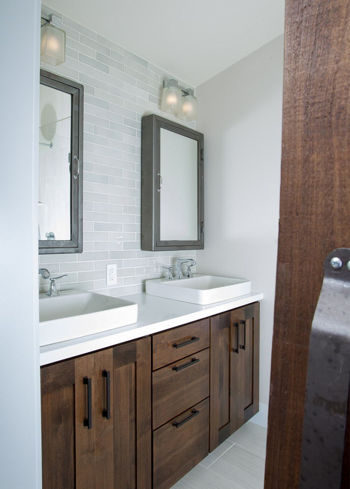 Design ideas for a mid-sized transitional 3/4 bathroom in San Francisco with shaker cabinets, dark wood cabinets, marble benchtops, gray tile, glass tile, white walls, light hardwood floors and a vessel sink.