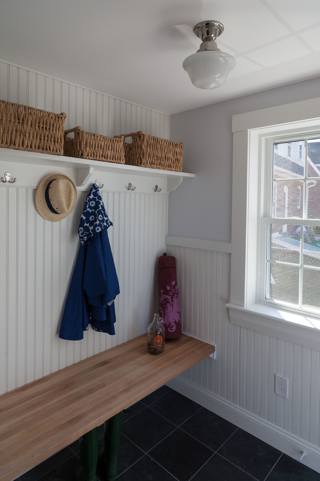 Mid-sized beach style mudroom in Boston with grey walls, slate floors and black floor.