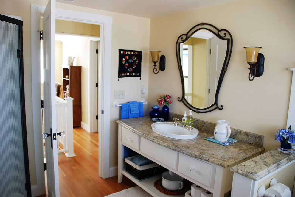 Mid-sized arts and crafts kids bathroom in Seattle with flat-panel cabinets, white cabinets, a freestanding tub, a corner shower, a two-piece toilet, beige walls, medium hardwood floors, a drop-in sink and granite benchtops.