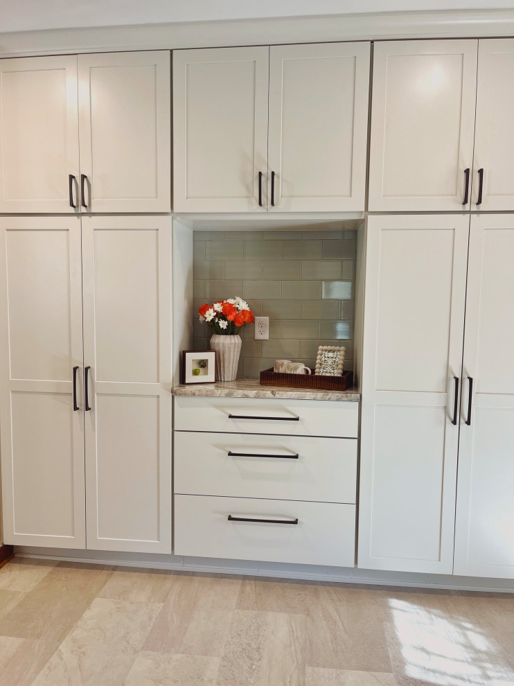 Inspiration for a mid-sized transitional l-shaped vinyl floor and beige floor eat-in kitchen remodel with a farmhouse sink, shaker cabinets, medium tone wood cabinets, quartzite countertops, green backsplash, ceramic backsplash, stainless steel appliances, no island and beige countertops