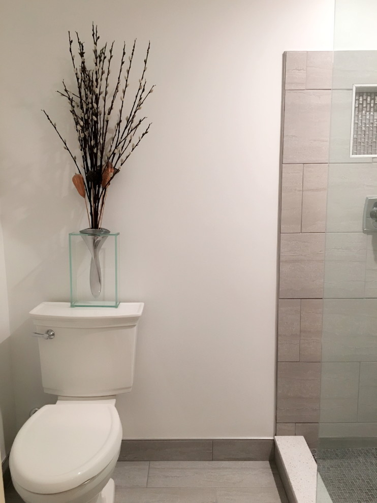 Alcove shower - mid-sized transitional porcelain tile, beige tile and brown tile porcelain tile and beige floor alcove shower idea in Detroit with a two-piece toilet and beige walls