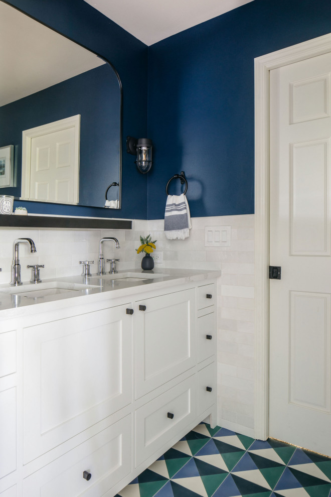 Inspiration for a small traditional kids bathroom in Chicago with raised-panel cabinets, white cabinets, a drop-in tub, blue tile, subway tile, cement tiles, engineered quartz benchtops, white benchtops, a double vanity and a built-in vanity.
