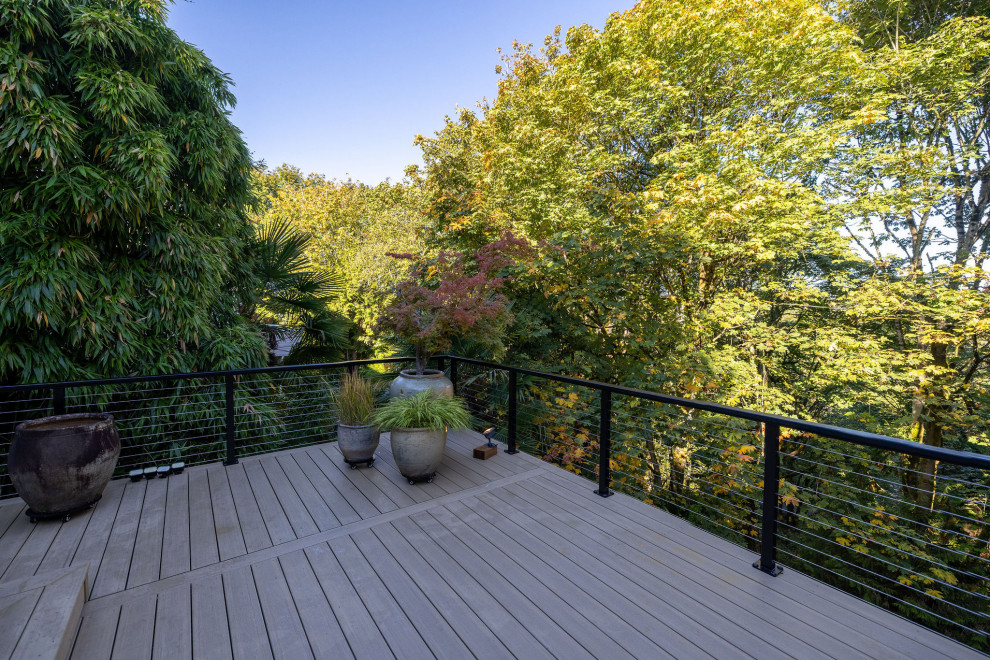 Deck - mid-sized backyard second story cable railing deck idea in Seattle