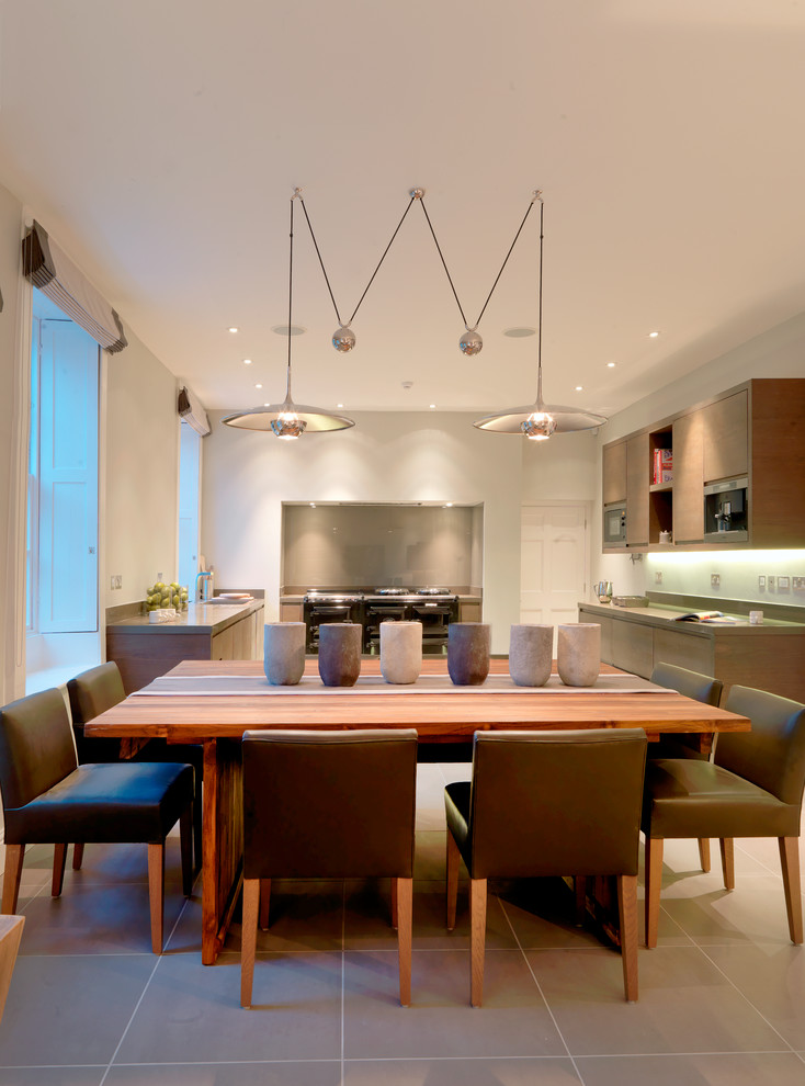 Photo of a mid-sized contemporary kitchen/dining combo in West Midlands with white walls, porcelain floors and no fireplace.