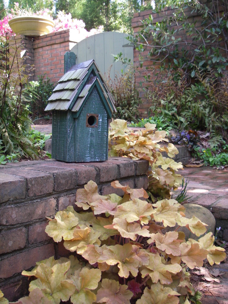 This is an example of a small traditional backyard garden in Atlanta with brick pavers.