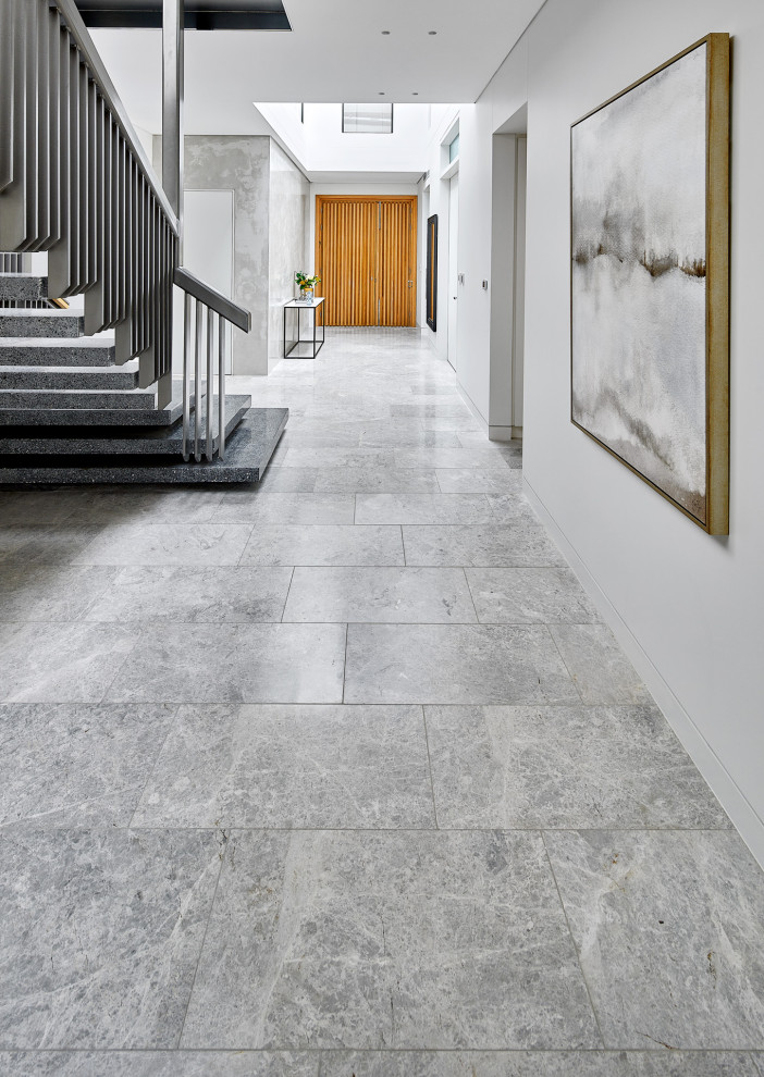 Photo of a contemporary foyer in Sydney with limestone floors and grey floor.