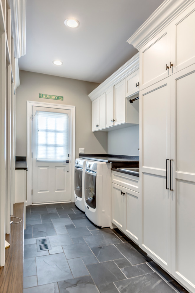 Example of a transitional slate floor utility room design in Chicago with a drop-in sink and gray walls