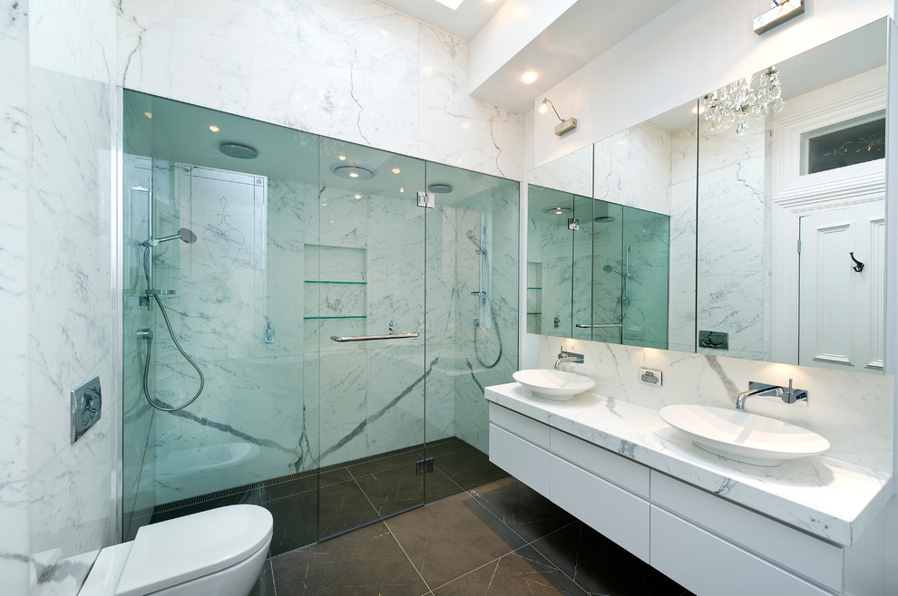 Photo of a large contemporary bathroom in Melbourne with a vessel sink, an alcove shower, marble benchtops and a hinged shower door.