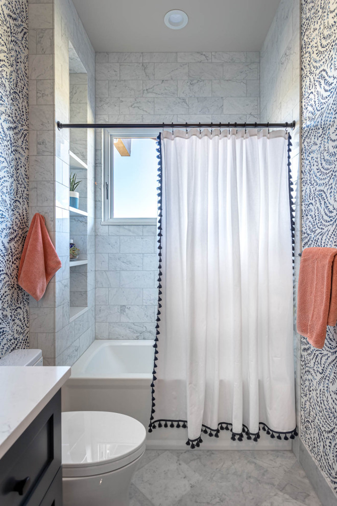 Стильный дизайн: детская ванная комната среднего размера в стиле неоклассика (современная классика) с фасадами в стиле шейкер, синими фасадами, ванной в нише, душем в нише, белой плиткой, каменной плиткой, разноцветными стенами, мраморным полом, врезной раковиной, столешницей из искусственного кварца, белым полом, шторкой для ванной, белой столешницей, нишей, тумбой под одну раковину, встроенной тумбой, любым потолком и обоями на стенах - последний тренд