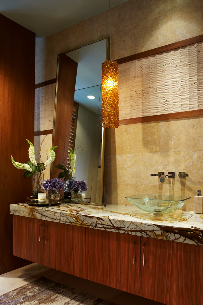 Inspiration for a contemporary powder room in Miami with a vessel sink, flat-panel cabinets and medium wood cabinets.