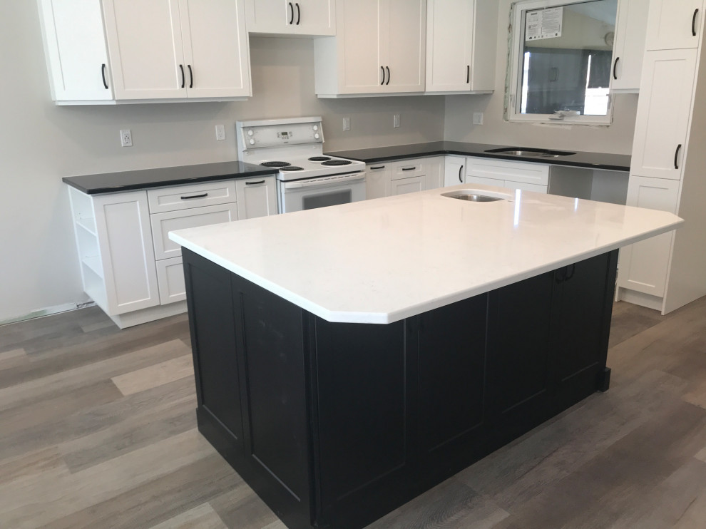 Inspiration for a mid-sized transitional l-shaped medium tone wood floor and gray floor open concept kitchen remodel with an undermount sink, shaker cabinets, white cabinets, quartzite countertops, gray backsplash, subway tile backsplash, stainless steel appliances, an island and multicolored countertops