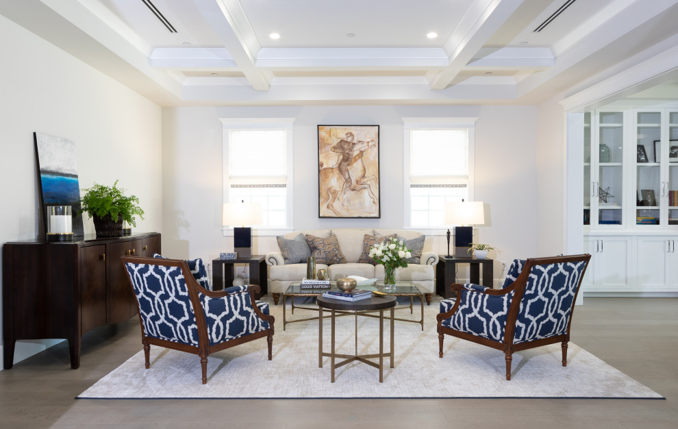 Example of a large beach style open concept light wood floor and gray floor living room design in Los Angeles with white walls, no fireplace and no tv