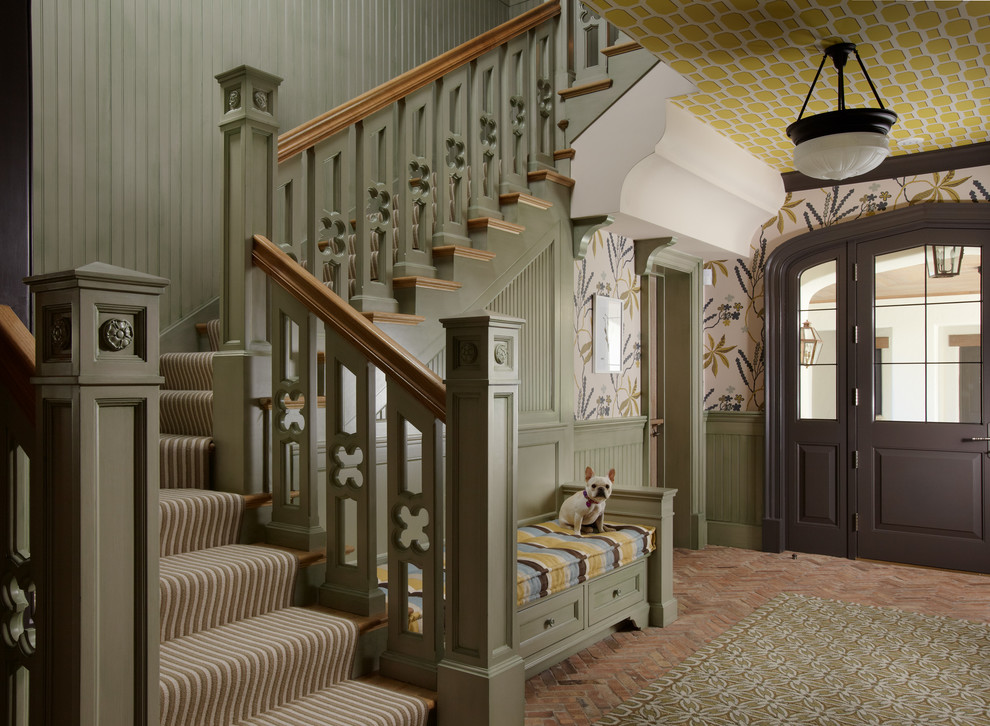 Traditional foyer in Miami with brick floors, multi-coloured walls, a single front door and a dark wood front door.