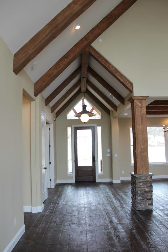 Mid-sized mountain style concrete floor foyer photo with a dark wood front door