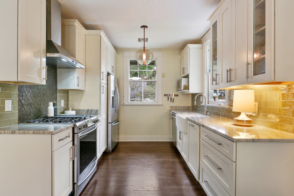 Design ideas for a small transitional eat-in kitchen in New Orleans with a farmhouse sink, shaker cabinets, white cabinets, marble benchtops, green splashback, glass tile splashback, stainless steel appliances, dark hardwood floors and no island.