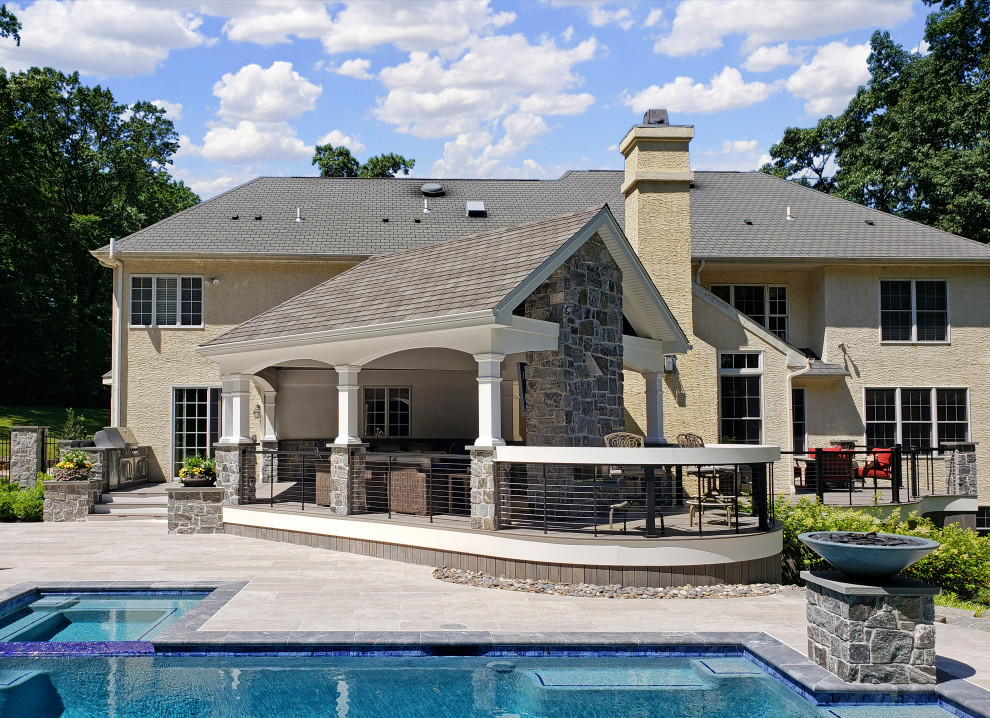 Inspiration for a transitional metal railing back porch remodel with a fireplace