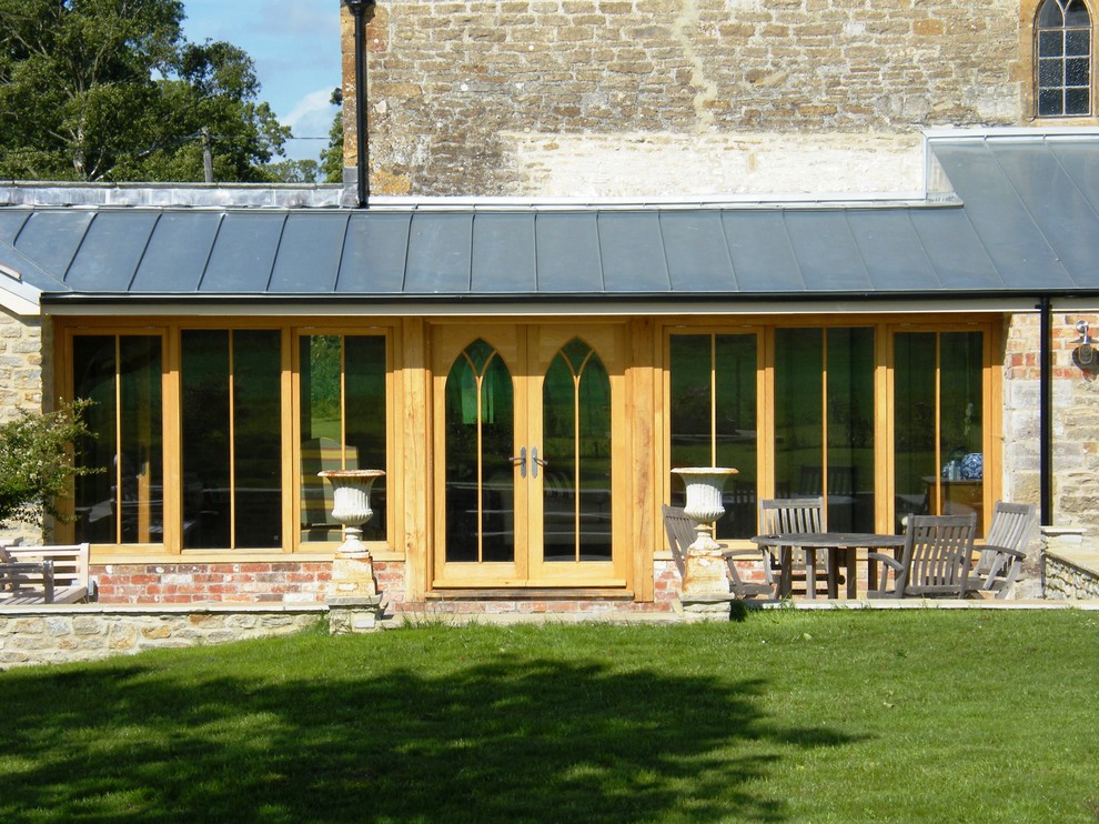 This is an example of a country exterior in Dorset with stone veneer.