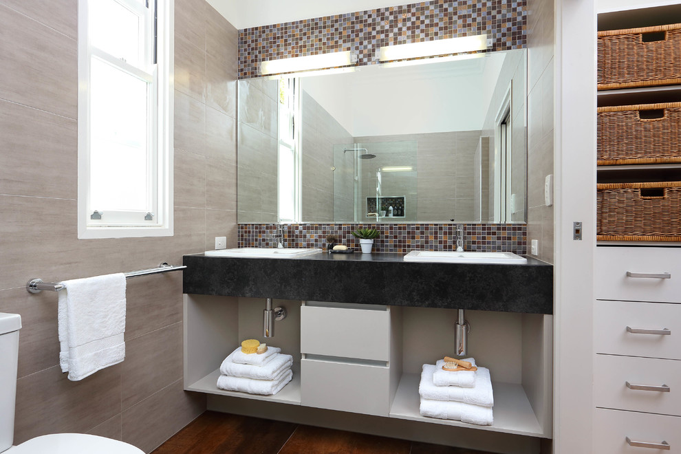 Design ideas for a small modern master bathroom in Brisbane with a drop-in sink, open cabinets, grey cabinets, granite benchtops, an open shower, a one-piece toilet, beige tile, ceramic tile, beige walls and porcelain floors.