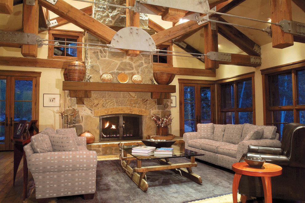 Inspiration for an expansive country living room in Salt Lake City with a standard fireplace, a stone fireplace surround and beige walls.