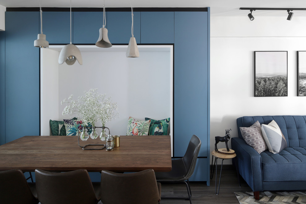 Photo of a contemporary open plan dining in Singapore with white walls, dark hardwood floors and brown floor.