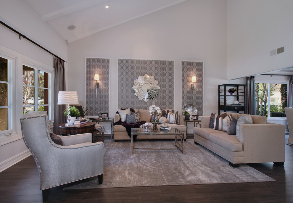 This is an example of a mid-sized traditional enclosed living room in Orange County with grey walls, dark hardwood floors, no fireplace and brown floor.