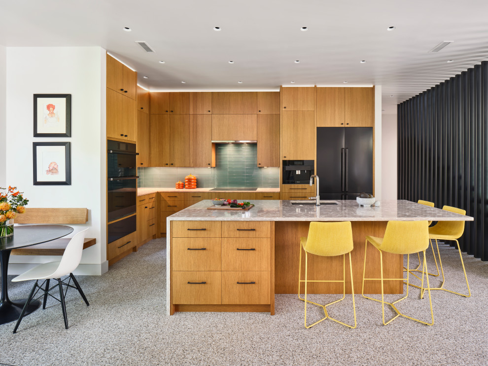 1960s single-wall open concept kitchen photo in Austin with an undermount sink, flat-panel cabinets, medium tone wood cabinets, quartzite countertops, glass tile backsplash, black appliances, an island and white countertops