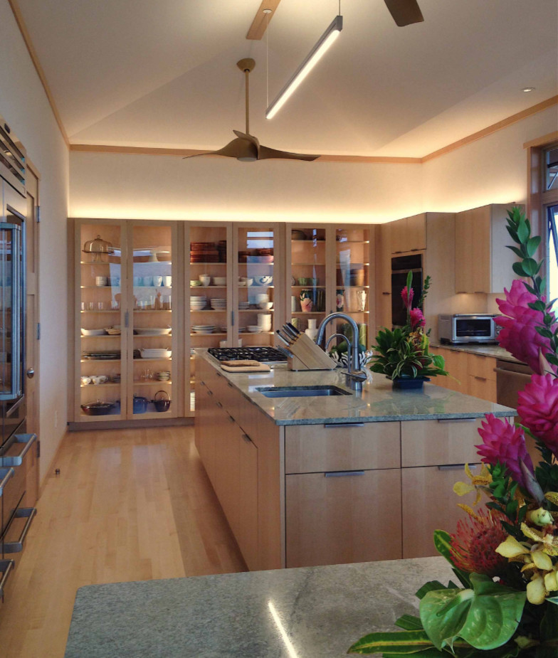 Photo of a large asian u-shaped separate kitchen in Hawaii with a drop-in sink, glass-front cabinets, light wood cabinets, granite benchtops, beige splashback, marble splashback, stainless steel appliances, bamboo floors, with island, beige floor and green benchtop.