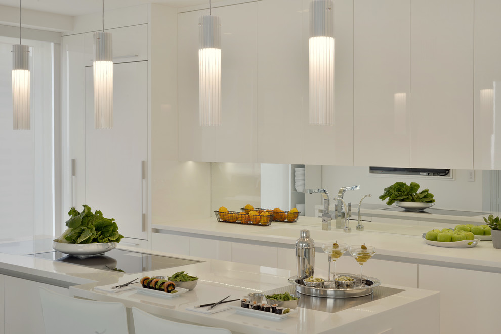 Photo of a small contemporary l-shaped separate kitchen in New York with an integrated sink, flat-panel cabinets, white cabinets, solid surface benchtops, mirror splashback, white appliances, porcelain floors, with island and beige floor.