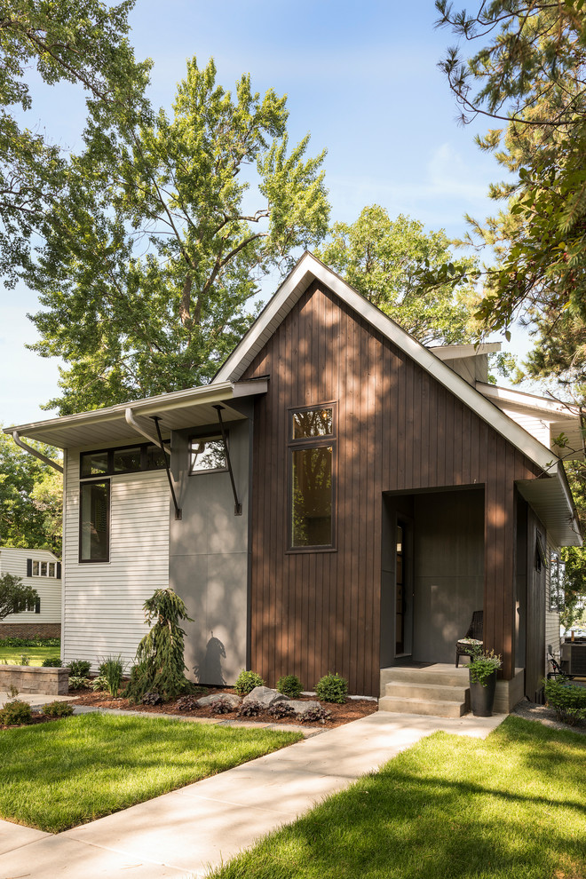 Transitional two-storey multi-coloured house exterior in Minneapolis with mixed siding.