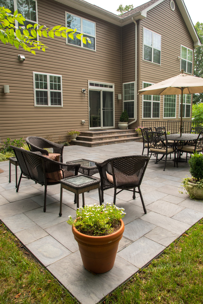 This is an example of a mid-sized backyard patio in DC Metro with concrete pavers.