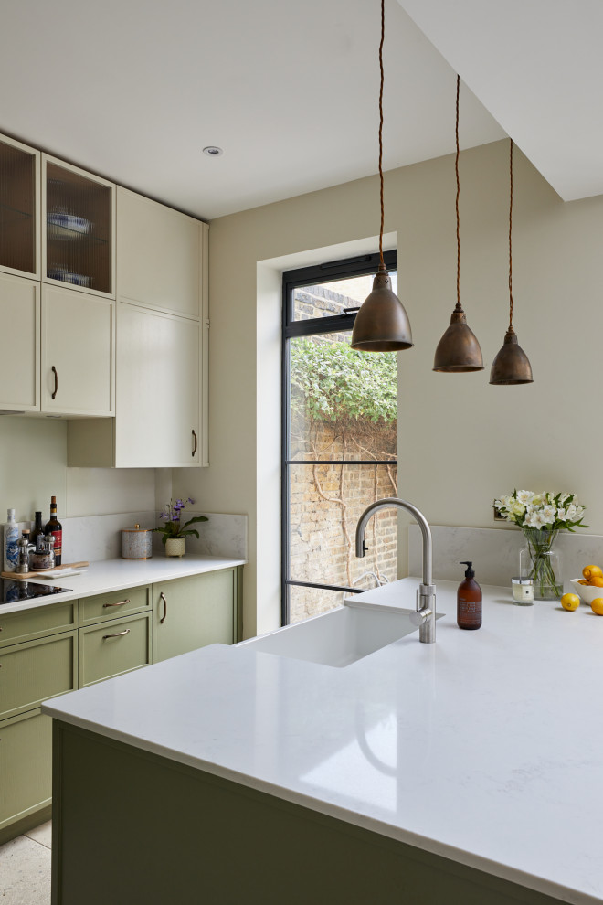 Small classic l-shaped enclosed kitchen in London with recessed-panel cabinets, green cabinets, quartz worktops, a breakfast bar and white worktops.