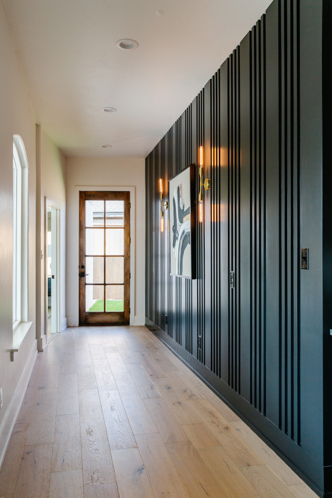 This is an example of a mediterranean hallway in Austin with black walls and wood walls.