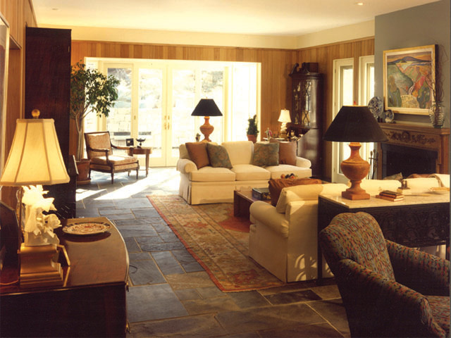 Photo of a mid-sized traditional living room in Atlanta with grey walls, slate floors, a standard fireplace, a wood fireplace surround, no tv and multi-coloured floor.