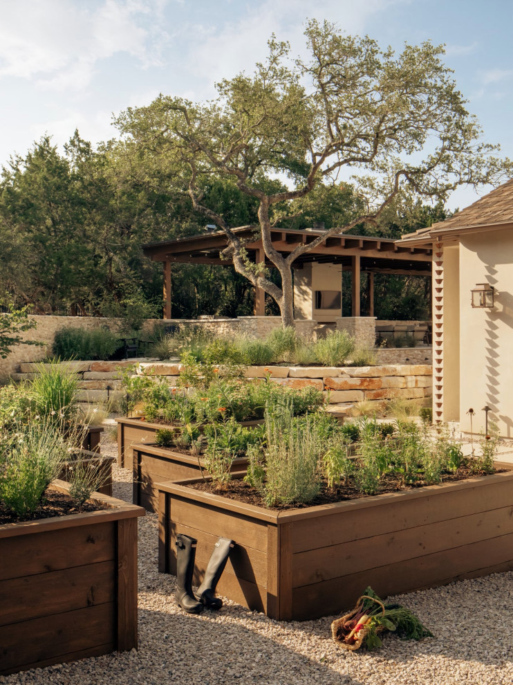 This is an example of a transitional full sun gravel vegetable garden landscape in Austin.