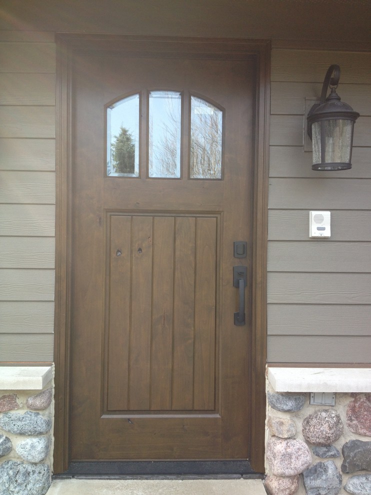 Photo of a mid-sized arts and crafts front door in Chicago with a brown front door and a single front door.