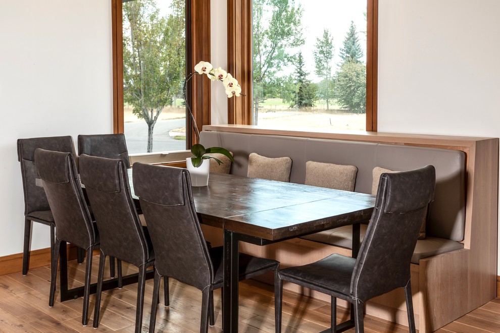 Dining room - small transitional medium tone wood floor dining room idea with white walls