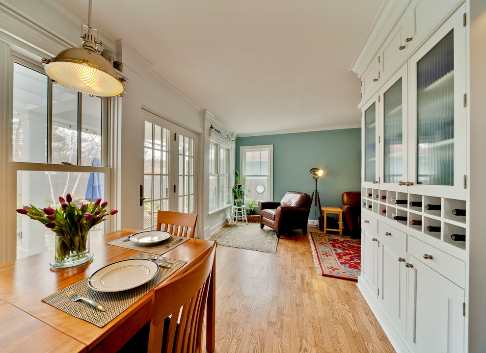 Photo of a mid-sized traditional open plan dining in Other with blue walls, light hardwood floors, no fireplace and brown floor.