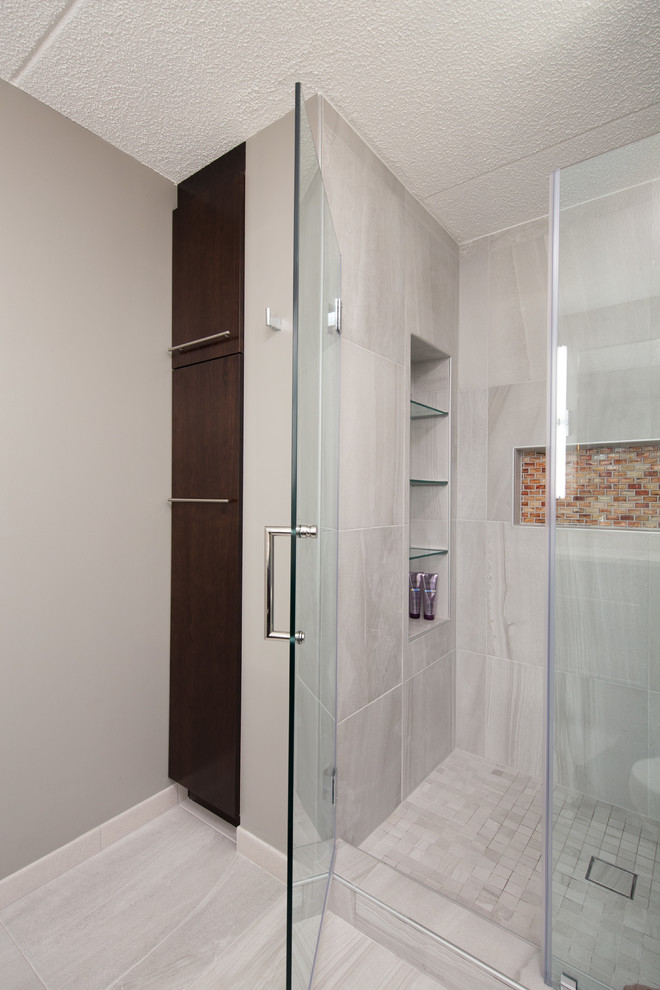 Design ideas for a mid-sized contemporary master bathroom in Chicago with flat-panel cabinets, dark wood cabinets, a curbless shower, a one-piece toilet, gray tile, stone tile, grey walls, ceramic floors, a drop-in sink and quartzite benchtops.