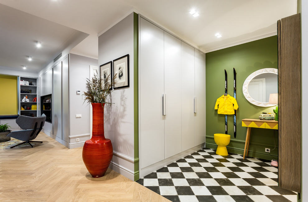 Mid-sized contemporary vestibule with green walls, ceramic floors, a single front door, a white front door and white floor.