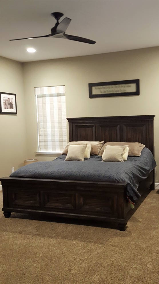 This is an example of an expansive transitional bedroom in Other with beige walls, carpet and beige floor.