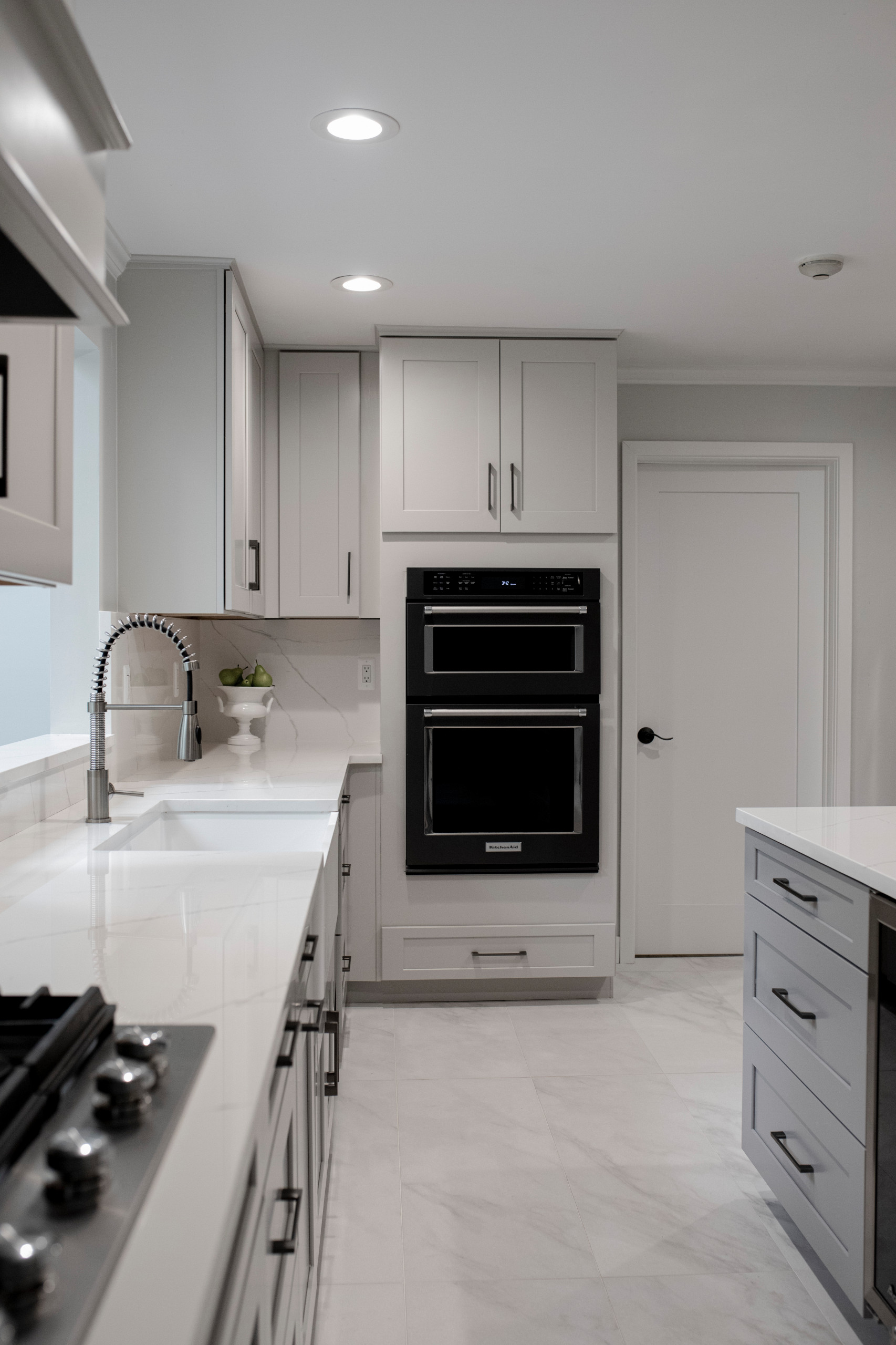 Large transitional u-shaped porcelain tile and white floor eat-in kitchen photo in Detroit with an undermount sink, shaker cabinets, gray cabinets, quartz countertops, white backsplash, quartz backspl