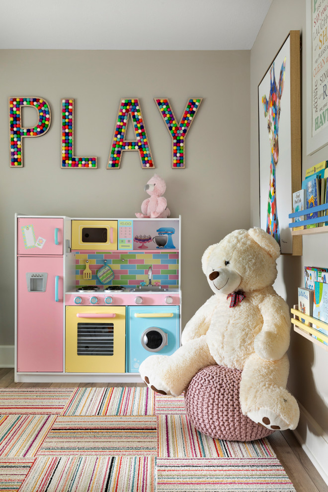 Photo of a mid-sized beach style gender-neutral kids' playroom for kids 4-10 years old in Minneapolis with white walls, vinyl floors and beige floor.