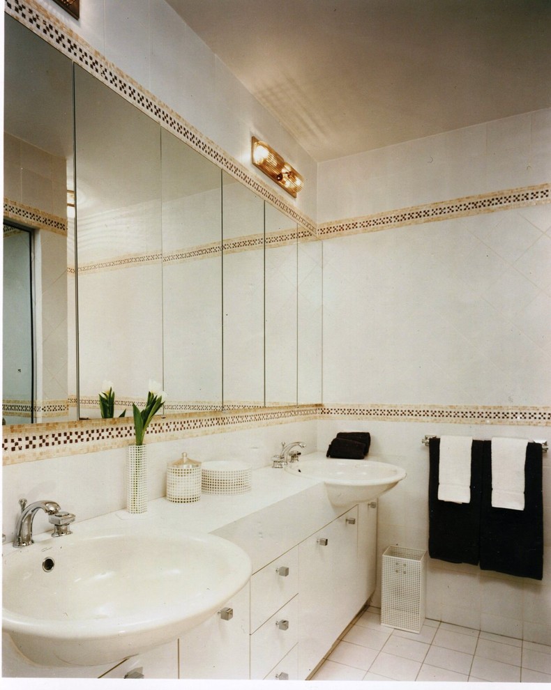 Photo of a large contemporary master bathroom in New York with flat-panel cabinets, white cabinets, an alcove shower, a two-piece toilet, white tile, stone tile, white walls, mosaic tile floors, a drop-in sink and granite benchtops.